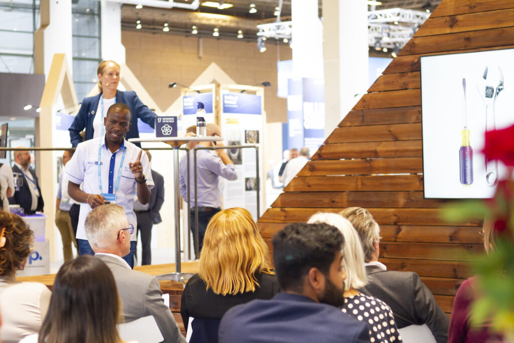 A male participant pitching his startup at the Harbourbasin stage at the IWA World Congress 2022.