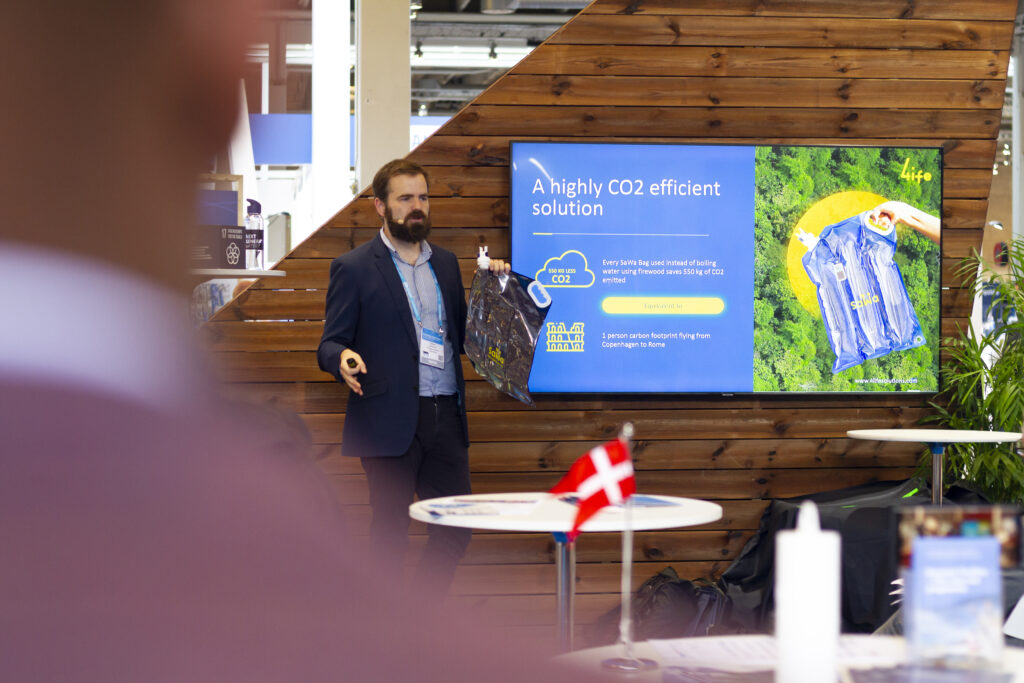 A male participant pitching his startup at the Harbourbasin stage at the IWA World Congress 2022.