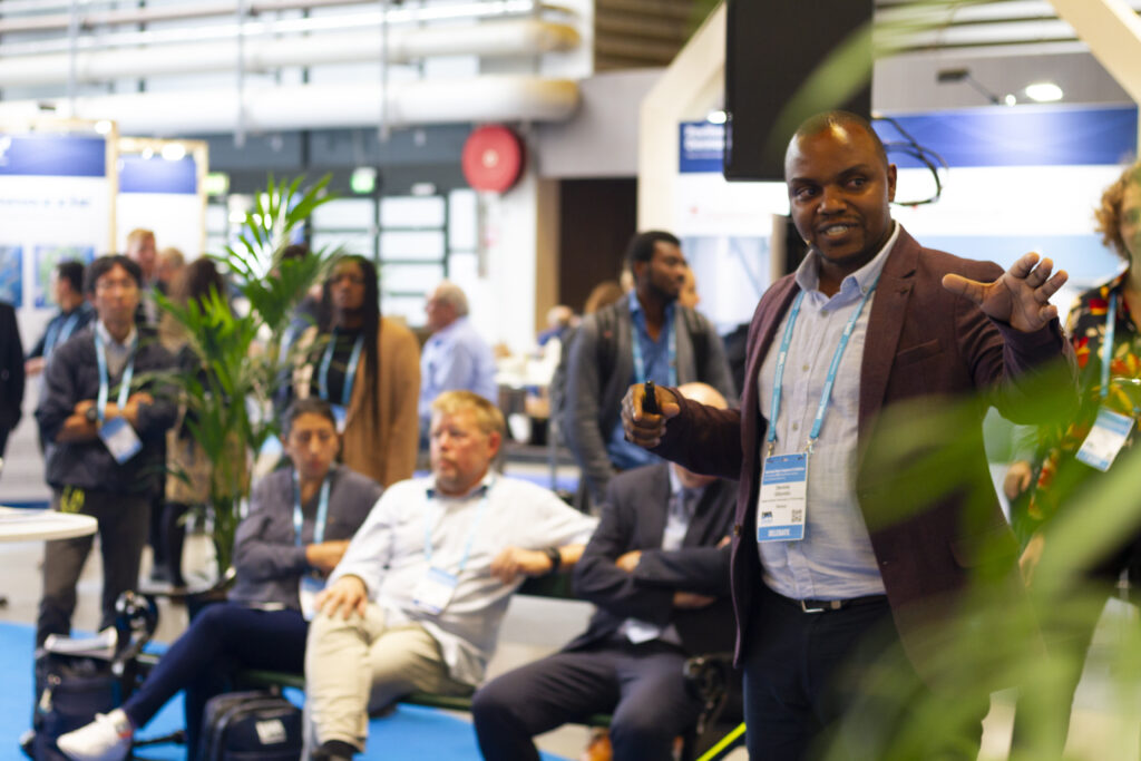 A male participant pitching his startup at the Harbourbasin stage at the IWA World Congress 2022.