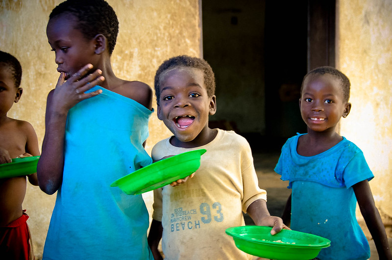 A group of children each holding a plate.